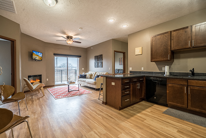 a kitchen and living room with a couch and a fire place
